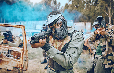 Image showing Paintball, teamwork and shooting with people in field for sports, target and fitness games. War, smoke and community with man gamer playing in camouflage for military, army and competition training