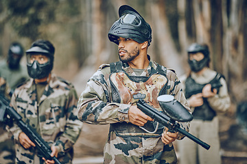 Image showing Paintball, sports and team with gun in woods ready for games, arena match and shooting battle outdoors. Adrenaline, adventure and people with weapons in camouflage, military clothes and action gear