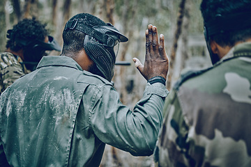 Image showing Hand sign, stop and men in training, paintball and planning, strategy and plan of action outdoor. Military, men and hands by guy leading team in sports, shooting and intense target practice together