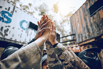 Image showing Paintball, group and high five for partnership, celebration and extreme sports success, victory for game time or goal. Team building, friends or people with gesture for war win or ready for combat