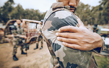 Image showing Injury, paintball and arm pain by man on field for team sport, fitness or training outdoor. Shoulder, problem and hands of guy with issue, arthritis or accident during exercise, match and performance