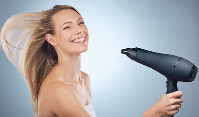 Image showing Haircare, hair dryer and beauty portrait of woman in studio isolated on a gray background. Balayage, face and happy female model with hairdryer product for hairstyle, grooming or salon treatment.