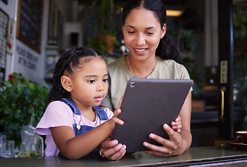 Image showing Digital tablet, coffee shop and mother with her child reading the online menu before ordering. Technology, internet and mom on a date with her girl kid with a touchscreen mobile device in a cafe.