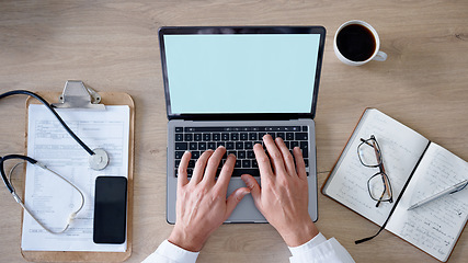 Image showing Healthcare, hands and laptop with a man doctor working at a desk in his office on a report from above. Medical, notebook and documents with a male medicine professional typing feedback on a computer