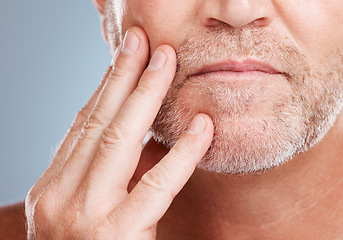 Image showing Skincare, beard and mature man in a studio for a hygiene, grooming and cosmetic facial routine. Health, wellness and male model touching his face for a beauty, natural and dermatology treatment.