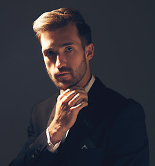 Image showing Portrait, fashion and man in formal suit, trendy and elegant with confident guy on dark studio background. Face, male and entrepreneur with fancy outfit, trendy clothes and executive with aesthetic