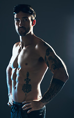 Image showing Fitness, sports and portrait of swimmer with tattoo isolated in studio for wellness, exercise and training. Workout, swimming athlete and man on dark background with muscles, strong body and goggles