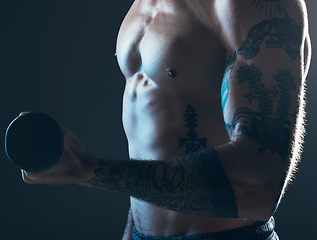 Image showing Fitness, body and man with dumbbell in hand on blue background, isolated neon blue light and muscular chest. Sports, muscle and male model in artistic dark studio for power workout and gym aesthetic.