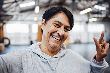 Image showing Gym, fitness and selfie of old woman with peace sign, smile and motivation for exercise in Brazil. Workout, happy training and mature lady in profile picture for social media with emoji hand gesture.