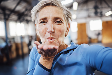 Image showing Senior woman, blowing kiss and fitness selfie at gym while happy after exercise, training or workout. Portrait of old person with smile for health, wellness and motivation for healthy lifestyle goals