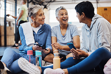 Image showing Fitness, gossip and senior friends with phone laughing at meme after yoga class, conversation and comedy on floor. Exercise, bonding and happy mature women checking social media together at workout.