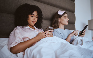 Image showing Friends, sleepover and phone with women in bed for communication, internet and contact. Happy, relax and connection with girl lying in bedroom with technology, digital streaming and social media