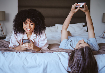 Image showing Video call, phone and friends with women at sleepover for communication, internet and contact. Happy, relax and smile with girl lying in bedroom with technology, digital and social media together