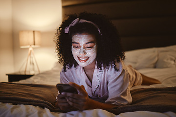 Image showing Skincare, face mask and woman on a phone in her bedroom networking on social media or mobile app. Beauty, self care and female browsing the internet or typing a message while relaxing on her bed.