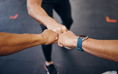 Image showing Group fist bump, hands and gym for motivation with personal trainer for health, wellness or training with smartwatch. Team, workout or exercise for fitness goal, muscle development or body healthcare