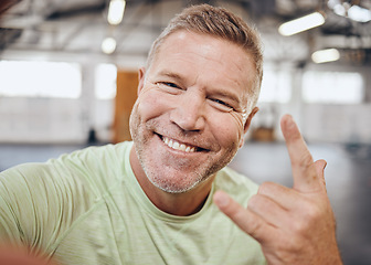 Image showing Selfie, fitness and portrait of man in gym with rock hand sign for muscle, wellness and cardio workout. Smile, healthy body and face of senior male for bodybuilder training, exercise and sports goals