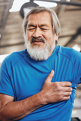 Image showing Sports, gym and old man with pain in chest, medical emergency during workout at fitness studio. Exercise, health and wellness, stressed asian senior person with hand on heart while training in Japan.