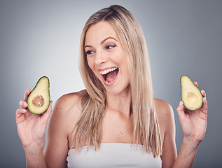 Image showing Beauty, avocado and skin or hair care of a woman in studio with natural cosmetics and shampoo for shine. Face of aesthetic model excited on a grey background for hairdresser or sustainable product