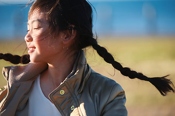 Image showing Playful, happy and Asian girl in nature for freedom, running and summer on a field in Singapore. Exercise, free and carefree little child in a park on a bokeh background for playing and happiness