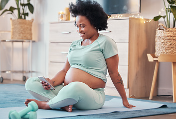 Image showing Yoga, pregnant and black woman with phone in home for social media and texting on workout break. Pregnancy, zen pilates and female with mobile smartphone for web browsing or scrolling after training.