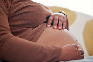 Image showing Pregnancy, maternity and woman touching her belly to play with baby bump in her house. Prenatal, love and pregnant African female holding her stomach for motherhood, maternal love and care at home.