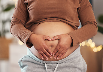 Image showing Heart hands on belly, pregnant mother and closeup of happy black woman alone in Africa living room. Excited future parent, holding healthy abdomen at home and loving mommy in pregnancy care