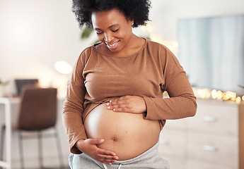 Image showing Pregnant, stomach and smile of black woman in home for maternity leave, health and wellness. Pregnancy, prenatal motherhood and female, mama or future mother touching belly with care for healthy baby