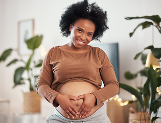 Image showing Pregnant mother, heart hands on belly and portrait of happy black woman alone in Jamaica living room. Excited future parent, holding healthy abdomen at home and natural beauty in pregnancy care