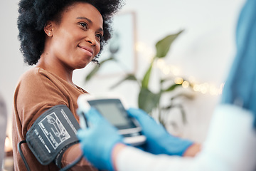 Image showing Black woman, healthcare and blood pressure machine in checkup with caregiver for monitoring pulse at home. Happy African American female patient or visit from medical nurse for health and wellness