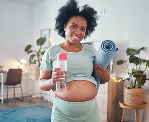 Image showing Pregnant, yoga and portrait of black woman in home ready to start exercise, training or workout for health or fitness. Pregnancy, zen pilates and future mother with mat and water bottle for hydration