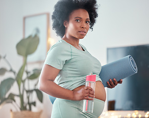 Image showing Yoga, pregnant and portrait of black woman in home ready to start exercise, training or workout for health or fitness. Pregnancy, zen pilates and future mother with mat and water bottle for hydration