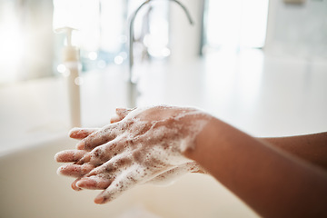 Image showing Woman, hands and cleaning with soap, water and tap at home for hygiene. Closeup, hand skincare and bacteria risk in bathroom, house and safety for healthy lifestyle, wellness and self care at sink