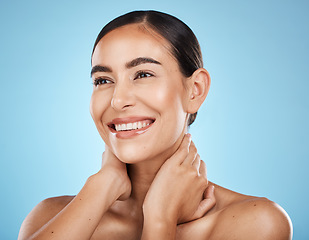 Image showing Woman, face and smile, happy and facial with natural cosmetics and beauty isolated against blue background. Clean, cosmetic care and hands with glow, makeup and healthy skin with skincare in studio