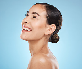 Image showing Skincare, wellness and woman in studio with a healthy, natural and cosmetic face treatment. Beauty, cosmetics and happy female model from Brazil with makeup facial routine isolated by blue background