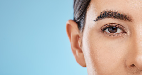 Image showing Skincare, beauty portrait and eye wellness of a woman with mockup with makeup and cosmetics. Blue background, studio and isolated model face with microblading eyebrow and eyes health aesthetic