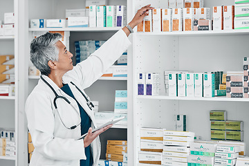 Image showing Pharmacy, tablet and medicine with senior woman in store for healthcare, wellness or retail. Product, technology and stock with pharmacist checking drugs outlet for shopping, medical or inventory