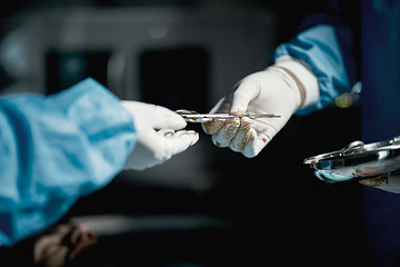 Image showing Surgeon, hands and medical scissors for a surgery on a emergency, operation or surgical room. Healthcare, people and team of doctors operating on a patient with steel tools in a medicare hospital.