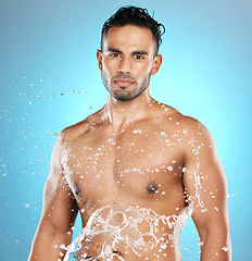 Image showing Portrait, splash and beauty, skin and skincare man cleaning his body, muscle and topless. Water, male and wellness model with moisture, cosmetic and hydration isolated in studio blue background
