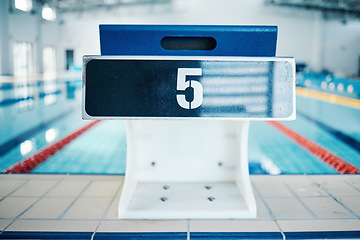 Image showing Sports, swimming pool and number on podium for training, exercise and workout for triathlon competition in gym. Fitness, motivation and five on professional starting block for dive, start and race