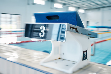 Image showing Swimming pool, sports and podium number by water for training, exercise and workout for triathlon competition. Fitness, motivation and three on professional starting block for dive race and diving