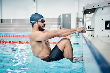 Image showing Sports, swimming pool and man start race in water for training, exercise and workout for competition. Fitness, motivation and professional male athlete with hands on starting podium for back stroke