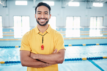 Image showing Portrait, proud and coach at a swimming pool for training, exercise and practice at indoor center. Face, happy and personal trainer ready for teaching, swim and athletic guidance, smile and excited