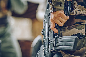 Image showing Paintball, military or hands with a gun in a shooting game playing with on a fun battlefield mission. Zoom, soldier or focused man with weapons gear for survival in an outdoor warrior competition