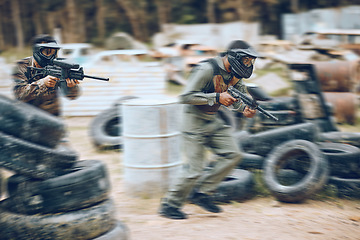 Image showing Paintball, running or men in a shooting game playing with speed or fast action on a battlefield. Mission focused, military or warriors training with a gun or weapon gear for survival in a competition