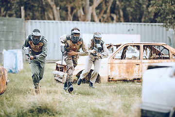 Image showing Paintball, mission or men running in a shooting game playing with speed or fast action on a fun battlefield. Focus, military or players with guns or weapons for survival in an outdoor competition