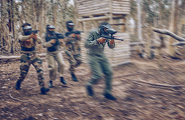 Image showing Paintball, team work or men running in a shooting game with speed or fast action on a fun battlefield. Mission focus, military or people with guns for survival in a competition in nature or forest