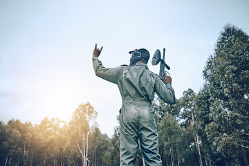 Image showing Paintball, rock hand sign or man in a shooting game playing on a fun battlefield with pride. Success, war winner or soldier with weapon or gun for in celebration of winning survival competition