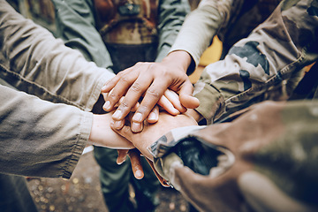 Image showing Military, team work or hands in a huddle for a mission, strategy or motivation on a paintball battlefield. Goals, collaboration or army people with support in a partnership or group of ready soldiers