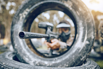 Image showing Gun, target or man in a paintball shooting game playing on a military battlefield on holiday vacation. Mission focus, army or sniper aiming with weapons gear for survival in an outdoor competition