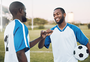 Image showing Fist bump, soccer ball and black man with teamwork success of sports training on a grass field. Football friends, support and exercise with fitness motivation outdoor for health workout and smile